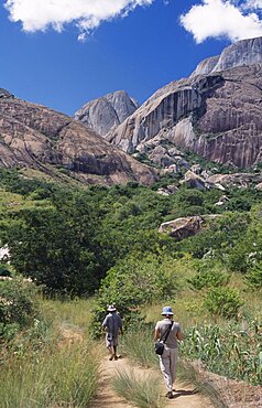 MADAGASCAR  Ambalavao A tourist being lead by a guide towards rocky mountains and trees in the Anjaha Nature Reserve   Anja