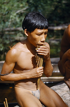 COLOMBIA Vaupes Region Tukano Tribe Boy playing the  carizu  / panpipes at the maloca s river port on the rio Piraparana Tukano / Makuna       Indigenous Tribes  rio Piraparana North West Amazonia Amazon American Colombian South America Vuapes Columbia Hispanic Indegent Latin America Latino Vaupes Tukano Tucano Turkano