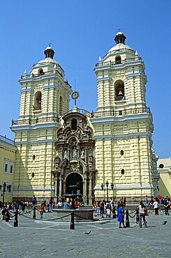 PERU  Lima San Francisco baroque church and monastery. Travel Tourism Holiday Vacation Explore Recreation Leisure Sightseeing Tourist Attraction Tour Destination San Francisco Baroque Lima Peru Peruvian South America Blue Sky Tranquility Tranquil Vivid Vibrant City Capital Tradition Traditional Culture Cultural Building Architecture Architectural Church Churches Religion Religious Pray Prayer Worship Worshipping Worshiping Christianity Holy Divine Christian Theology Faith Sacred Devout Catholic Catholicism Magnificent Impressive Majestic Faade Edifice Bell Tower Spire Steeple Landmark Ethnic Dominant Dominating Prominent People Visitors Converge Converging Convergent UNESCO World Heritage Site Monastery Monasterio Colonial Courtyard Yellow Calendar American South America