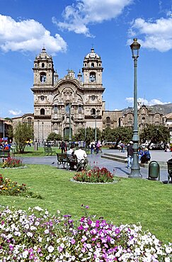 PERU  Cusco Looking across Plaza de Armas to Iglesia La Compania de Jesus. Cuzco Travel Tourism Holiday Vacation Explore Recreation Leisure Sightseeing Tourist Attraction Tour Destination Plaza De Armas Cusco Cuzco Peru Peruvian South Southern America Latin Sacred Valley Of The Inca Incas Vivid Vibrant City Town Square Tranquil Tranquility Tradition Traditional Culture Cultural Buildings Architecture Architectural Ethnic UNESCO World Heritage Site Andes Andean View Vista Spanish Colonial Scenic Picturesque Backdrop People Visitors Park Garden Path Pathway Iglesia La Compania Jesus Jesuit Church Churches Religion Religious Pray Prayer Worship Worshipping Worshiping Christianity Holy Divine Christian Theology Faith Sacred Devout Catholic Catholicism Spectacular Beautiful Quiet Blue Sky Magnificent Lawn Grass Flowers Calendar American South America