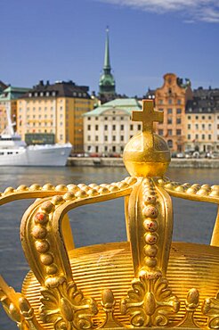 SWEDEN  Stockholm Close-up of an ornamental crown on Skeppsholmsbron with Gamla Stan in the background. travel Scandinavia Sweden Stockholm Northern Europe Swedish European