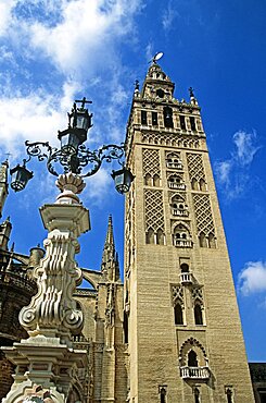 SPAIN Andalucia Seville Cathedral Bell tower  Plaza Virgen de los Reyes. Travel Tourism Holiday Vacation Explore Recreation Leisure Sightseeing Tourist Attraction Tour Destination Trip Journey Seville Sevilla Andalucia Andalucian Andalusia Andalusian Spain Spanish Espana Europe European Union EU City Culture Cultural Building Architecture Architectural History Historic Historical Landmark UNESCO World Heritage Site Iglesia Cathedral Catedral Church Churches Religion Religious Pray Prayer Worship Worshipping Worshiping Christianity Holy Divine Christian Theology Faith Sacred Devout Catholic Catholicism Faade Edifice Bell Tower Spire Steeple Gothic Horizontal Street Light Streetlight Streetlamp Lamp Lighting Vacation Espainia Espanha Espanya European Union Hispanic Religion Religious Christianity Christians Southern Europe