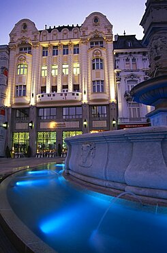 SLOVAKIA  Bratislava Part view of Maximillian Fountain and the Cafe Rolanda on Hlavne nam  main square  at night.