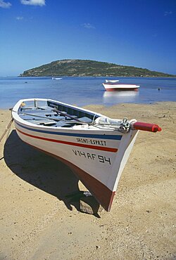 MAURITIUS General  Fishing boat on beach with Ile Morne behind