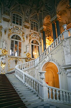 The Winter Palace of the Hermitage Museum, Detail of the Jordan Staircase and opulent white and gold interior decoration, St Petersburg, Russia