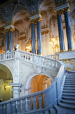 The Winter Palace of the Hermitage Museum, Detail of the Jordan Staircase and opulent white and gold interior decoration and marble columns, Visitors on balcony, St Petersburg, Russia