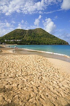 Reduit Beach in Rodney Bay during the early morning with tourists walking by the waterline, Gros Islet, St Lucia