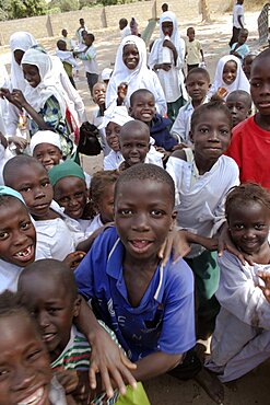 Tanji Village, Happy laughing children full of energy and wanting to be photographed trying to get the best position while on a break from lessons at the Ousman Bun Afan Islamic school, Tanji, Western Gambia, The Gambia