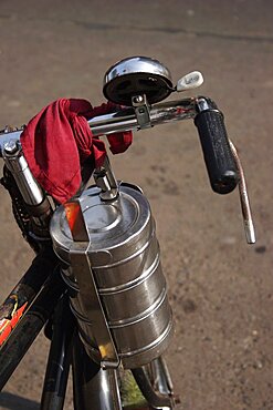 Cropped shot of bicycle with tiffin box tied to handlebars, Mumbai, Maharashtra, India