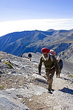 Olympus, Group of four climbing steep slope of Mount Olympus towards the highest peak called Mytikas, Pieria, Macedonia, Greece