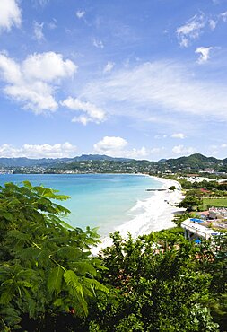 Aquamarine sea and the two mile stretch of the white sand of Grand Anse Beach with St. Georges in the distance, Grenada, West Indies, Caribbean, Central America