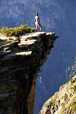 Cliff edge with figure looking into ravine Taft Point, United States of America