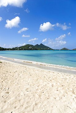 Waves breaking on Paradise Beach at LEsterre Bay with the turqoise sea and The Sister Rocks beyond, Caribbean