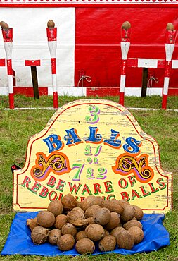 Findon village Sheep Fair Coconut shy with sign reading Beware of Rebounding Balls, United Kingdom