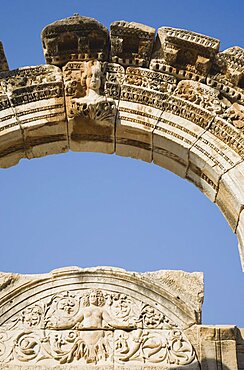 Turkey, Izmir Province, Selcuk, Ephesus, Detail of carved archway and wall relief against clear blue sky in ancient city of Ephesus on the Aegean sea coast