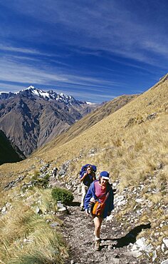 PERU Cusco Department The Inca Trail Treckers with back packs walking up Dead Woman?s Pass.  View towards the mountains behind them.  Cuzco