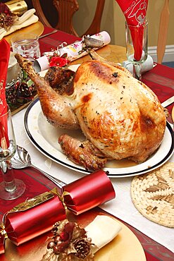 Food, Cooked, Poultry, A whole turkey ready for carving on a table laid for Christmas lunch.