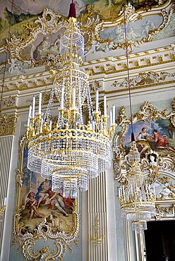 Germany, Bavaria, Munich, Nymphenburg Palace. Interior of Steinerner Saal the Stone or Great Hall with detail of paintings elaborate chandelier and gold and white baroque decoration by Francois de Cuvillies.