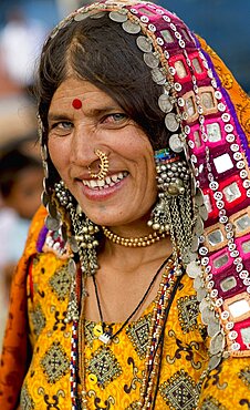 Smiling Lambani Gypsy woman with gold nose ring Tribal forest dwellers now settled in 30-home rural hamlets Related to the Rabaris gypsies of Kutch Gujarat, People, Karnataka, India