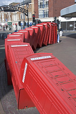 Red telephone box sculpture Out of Order by David Mach. Kingston Upon Thames, Surrey, England, United Kingdom, Europe