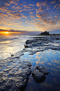 Spectacular sunrise over Bamburgh Castle, Northumberland, England, United Kingdom, Europe