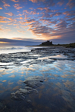 Spectacular sunrise over Bamburgh Castle, Bamburgh, Northumberland, England, United Kingdom, Europe