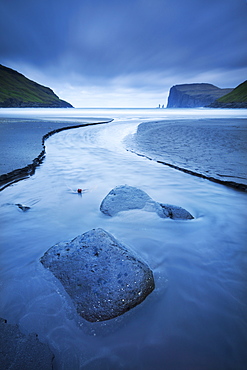 A stream runs into the sea at Tjornuvik on the island of Streymoy in the Faroe Islands, Denmark, Europe