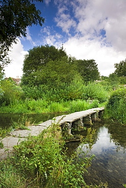 Stone clapper bridge over the River Leach at Eastleach Turville in the Cotswolds, Gloucestershire, England, United Kingdom, Europe 