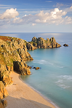 Pednvounder Beach backed by Logan Rock on Treryn Dinas headland, Porthcurno, Cornwall, England, United Kingdom, Europe 