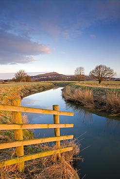 First light of morning on Glastonbury Tor viewed from the River Brue, Somerset Levels, Glastonbury, Somerset, England, United Kingdom, Europe 