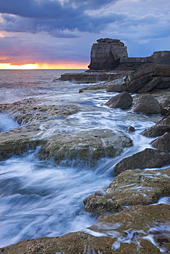 Waves crash against the rocky coast of Portland Bill at sunset. Isle of Portland, Jurassic Coast, UNESCO World Heritage Site, Dorset, England, United Kingdom, Europe 