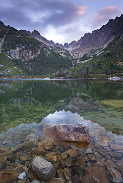 A mirror still Popradske Pleso lake in the High Tatras, Tatra Mountains, Slovakia, Europe 