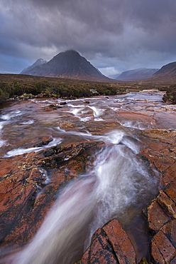 Stream rushing through Rannoch Moor towards the iconic mountain Buachaille Etive Mor, Highland, Scotland, United Kingdom, Europe