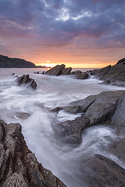 Colourful sunset sky above rocky Combe Martin on the north Devon coast, Exmoor National Park, Devon, England, United Kingdom, Europe