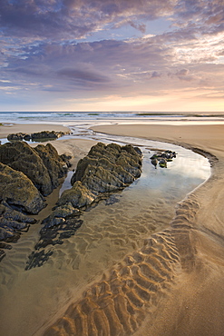 Rockpools on sandy Coombesgate Beach at low tide, Woolacombe, Devon, England, United Kingdom, Europe