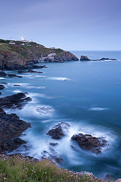 View from Lizard Point over rocky Polpeor Cove and onto the Lizard Lighthouse and old lifeboat Station, Lizard, Cornwall, England, United Kingdom, Europe