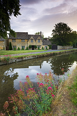 Cottages near the River Eye in the picturesque Cotswolds village of Lower Slaughter, Gloucestershire, England, United Kingdom, Europe