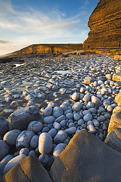 Golden evening sunshine lights up the rocks, Dunraven Bay, Southerndown, Wales, United Kingdom, Europe