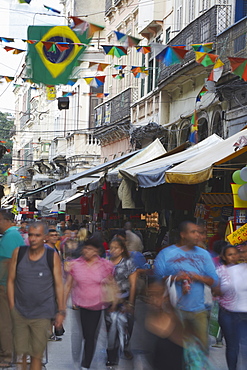 People walking along pedestrianised street of Saara district, Centro, Rio de Janeiro, Brazil, South America 