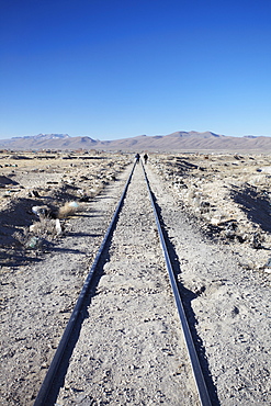 People walking along train tracks, Uyuni, Potosi Department, Bolivia, South America