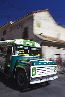 Bus passing along street, La Paz, Bolivia, South America