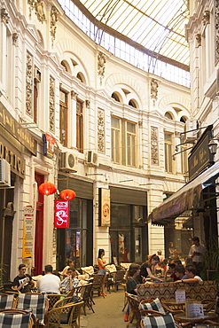 People at cafes in Macca-Villacrosse Passage, Bucharest, Romania, Europe