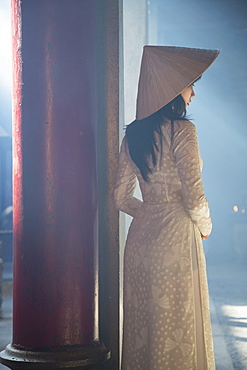 Woman wearing ao dai dress at Thien Hau Pagoda, Cholon, Ho Chi Minh City, Vietnam, Indochina, Southeast Asia, Asia