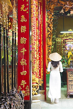 Woman wearing ao dai dress at Phuoc An Hoi Quan Pagoda, Cholon, Ho Chi Minh City, Vietnam, Indochina, Southeast Asia, Asia