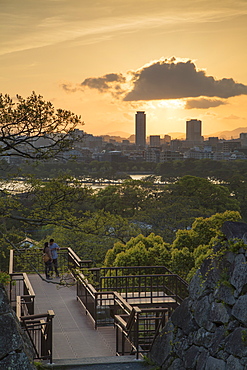 Couple at Fukuoka Castle ruins at sunset, Fukuoka, Kyushu, Japan, Asia