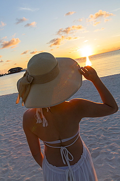 Woman on beach at Olhuveli Beach and Spa Resort, South Male Atoll, Kaafu Atoll, Maldives, Indian Ocean, Asia