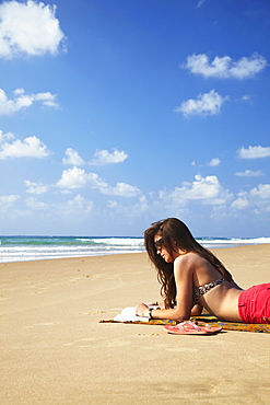 Woman reading on beach, Tofo, Inhambane, Mozambique, Africa