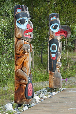 Totem poles with beaver image on the left and eagle image on the right, Tlingit Heritage Center, Teslin, Yukon, Canada, North America