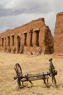 Old wagon wheels with remnants of Fort Union behind, Fort Union National Monument, New Mexico, United States of America, North America 