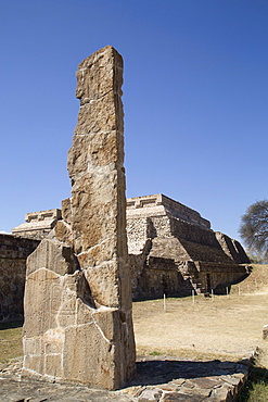 Stela 18 dating from 100 BC to 300 AD in foreground, with Building Group IV, Ceremonial Complex in the background, Monte Alban, UNESCO World Heritage Site, Oaxaca, Mexico, North America